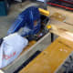 Using the biscuit joiner with the board held vertically against a fence.