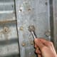 Keep a set of standard box-end wrenches handy on old bins, as not all bolts may be the same.