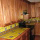 Yellow with multi-colored inset tiles and border.