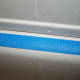 Place the tape along the tub lip, leaving a slight gap between the tape and the shower lining seam.