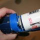 Slip the disc into the bottom of the caulking tube.