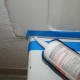 Start at one edge and begin squeezing and hold the trigger, dragging the gun across the seam to get as even a layer of caulk as you can.