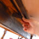 A small 4" piece of wood pivots to "lock" the board onto the old table.