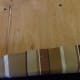 Pulling tightly, tack the fabric to each side of the wooden base with the staple gun.
