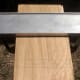 The guide is clamped in place, with the clamps completely under the surface and out of the way.