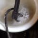 Soaking the terminal in baking soda and water. There is a vigorous chemical reaction going on, with lots of bubbling, as the corrosion is eaten away.