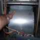 With those screws out, the blower should slide out toward you. Do not let the blower drop as it reaches the end of the slide.