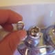 ...it pops off quite easily to access the screw. Perhaps even with just your fingernail.