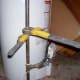 Here you see how the wrenches are applied to "break" the union so that you can take apart or finish up your gas line.