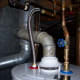 Here is the finished product on the top side. You can see where my new plumbing hooks into my old plumbing and the products and fittings I chose to use. This photo sums up a lot of this article. Notice I was able to reuse the same flue parts.