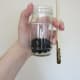Add moistened soil to your bottle or jar. Use a chopstick or pencil to keep it off the walls of the jar.