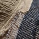 Begin on the back side of the rug and insert the needle.