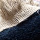 When coming up through the front side of the rug, make sure to catch the strip of fringe.