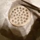 Cut out the circle 1/4 to 1/2 inch larger than drain.