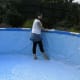 Erecting the pool, pushing out the creases before filling with water