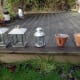 Mood setting outdoor candle lanterns and pots for decking.
