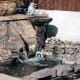 Water spouting from garden wall as part of the design feature.