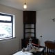View of corner unit in dining room, with room ready for painting.