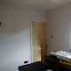 Room wallpapered, and ready for painting; view towards dining room door.