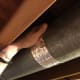 Finish peeling the backing off the tape and smooth over the top of the pipe as far as you can with your hand.