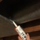 Begin applying mastic up as high as you can get your caulking gun.