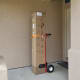 We used this red hand truck and a simple tie down to wheel the approximately 80 pound box to our second floor bedroom.