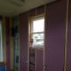 We added spray foam and pink poly-foam insulation with a higher R-value to the existing green foam to fill the wall cavity.