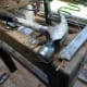 Using an old chisel with a claw hammer to remove all the upholstery nails.
