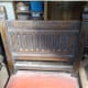 The carved solid oak back of the chairs.