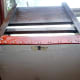 View of chair from underside, with manufacturer’s label affixed at the back.