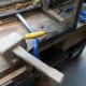 Using a chisel and mallet to clear out the old mortise joint.