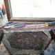 Using pliers and screwdriver to remove the upholstery tacks.