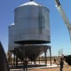 To set the bin up, the crane backed in close to the hopper, and cautiously extended the boom, after resetting the outriggers.
