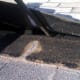 A closer view of the broken shingle half that must be removed. It had broken off just into the area normally seen, leaving only the dark, upper half.