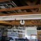 A high quality fixture being used as a shop light. It has 6 lamps and two ballasts, both on one end of the 8 foot fixture.