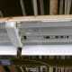 This fixture needs the entire reflective shield removed. One of the two plastic clips (on near each end) is shown here.