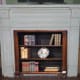 Small bookshelf in front of closed off fireplace