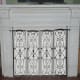 Art deco fireplace screen covering closed off fireplace