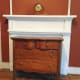 Dresser in front of closed off fireplace