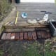 As the lawnmower can't get into tight spaces, laying bricks in small gap in front of decking before laying the boundary wire.