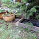 Boxed frame placed over Christmas tree water tray for protection.