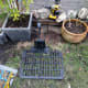 Robotic lawnmower charging base, with 2-way switch for switching between the two zones behind it (fixed under the decking front).