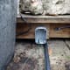 Wires fed through the drainage hole in the switch back box, ready for wiring the 2-way switch.