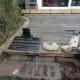 Laying the mains power cable under the decking for the charging base; lifted a decking up at the far end, and tied the plug to the end of a cane, and pushed it under the decking to the far end.