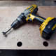 Drilling the holes in the plywood, where marked, to match with the design of the original decorative trim.
