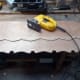 Using a jig saw to cut the wavy lines between the circular holes cut in the plywood; to make the new decorative trim match the original.