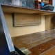 2 inch thick timber fixed to back of bureau so that the pigeon-holes can be butted against it to give a solid fixing.