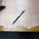 Marking the outline of the original decorative trim with a pencil, to give a guide for making the new trim.