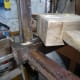 Using wooden mallet to gently separate leg joints far enough to apply glue in the gaps.