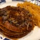 Red Tex-Mex enchiladas with a side of Mexican style rice.